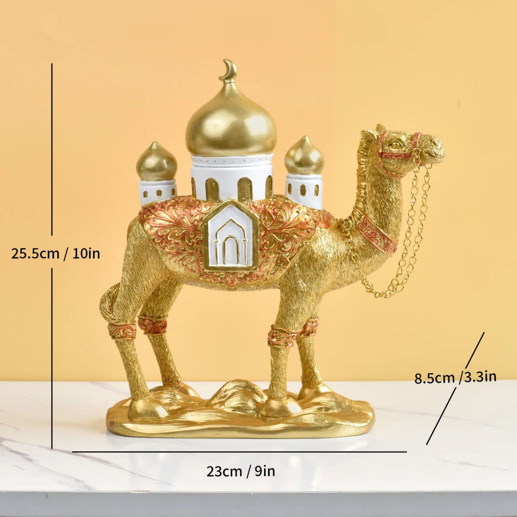 Decorative gold camel figurine with architectural elements on a beige background