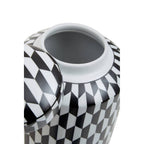 Geometric monochrome ceramic ginger jar styled on dark sideboard with gold accents