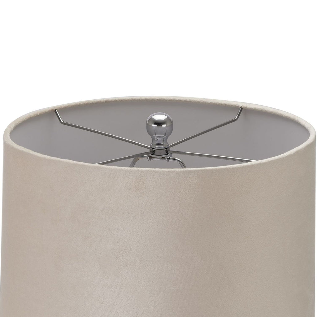 Close-up of a cylindrical lampshade in a warm beige fabric, showing the interior with a silver metal finial and support rods against a white background.
