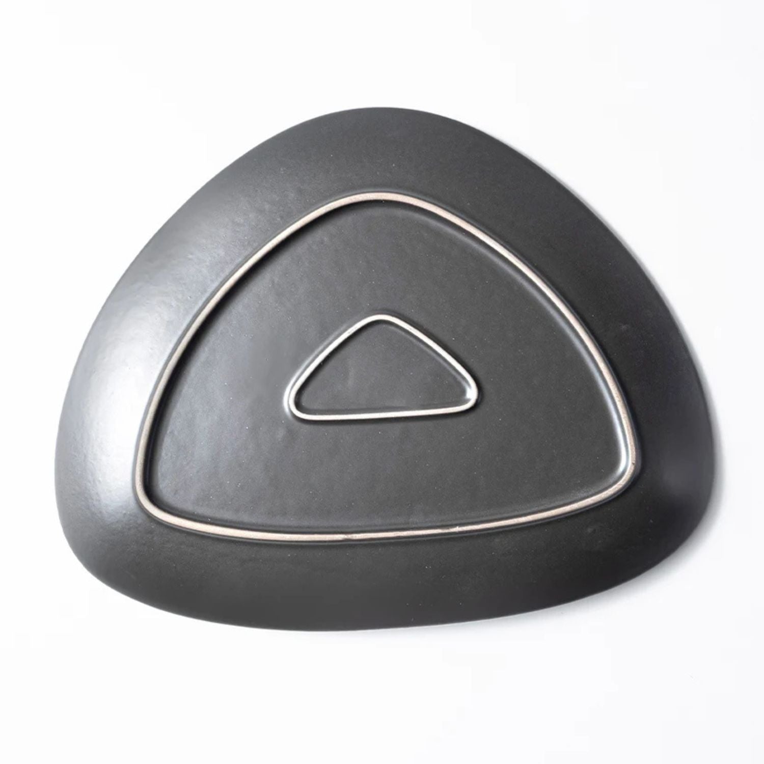 A dark gray, triangular-shaped car part with a textured finish and a silver metallic outline pattern, shown on a plain white background.
