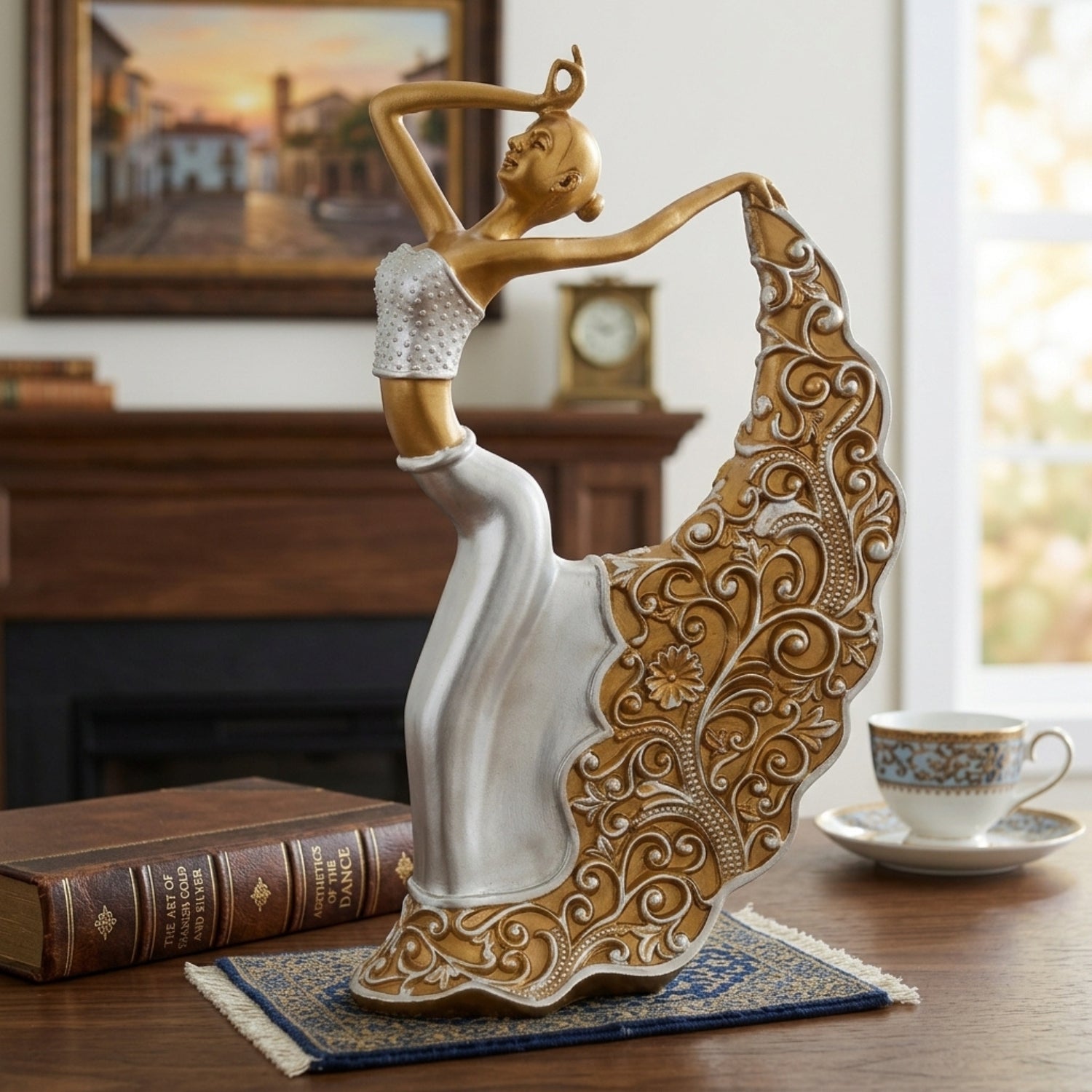 A decorative figurine of a dancing woman with a large flowing skirt, styled on a wooden table in a home interior setting next to a book and a teacup.