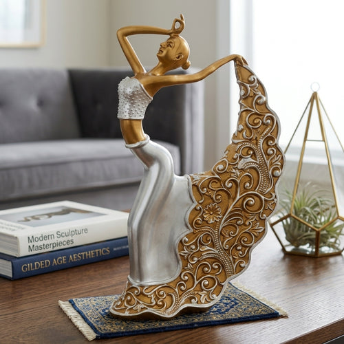 A decorative sculpture of a dancing woman with a flowing ornate skirt, shown on a wooden table in a styled living room setting with books and a plant.