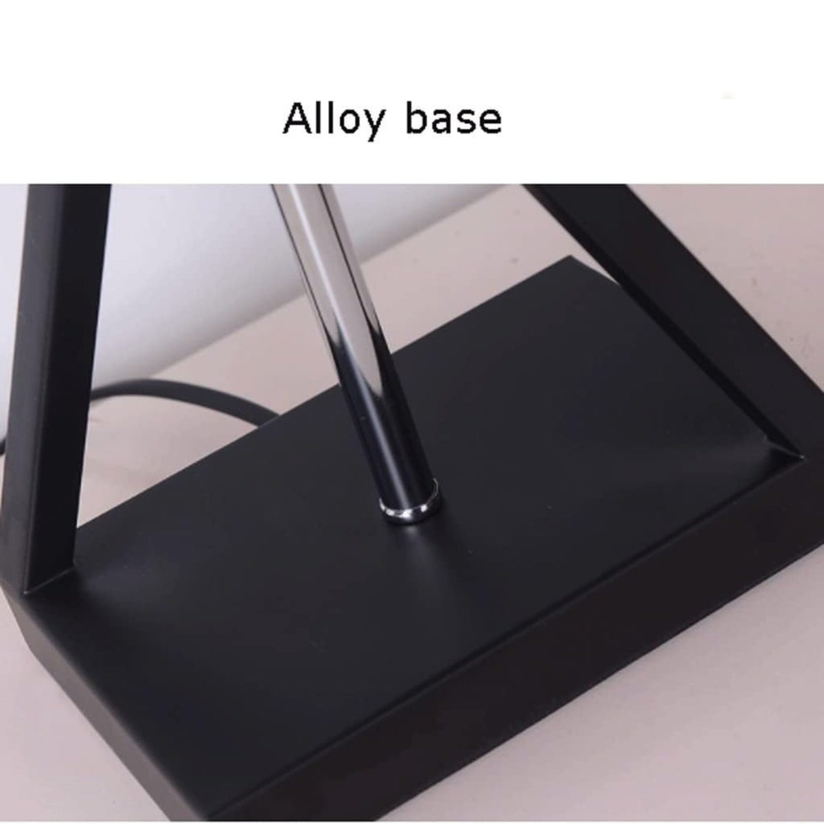 Close-up of a black metal desk lamp base with a vertical silver-colored alloy pole, labeled 'Alloy base' on a white background.