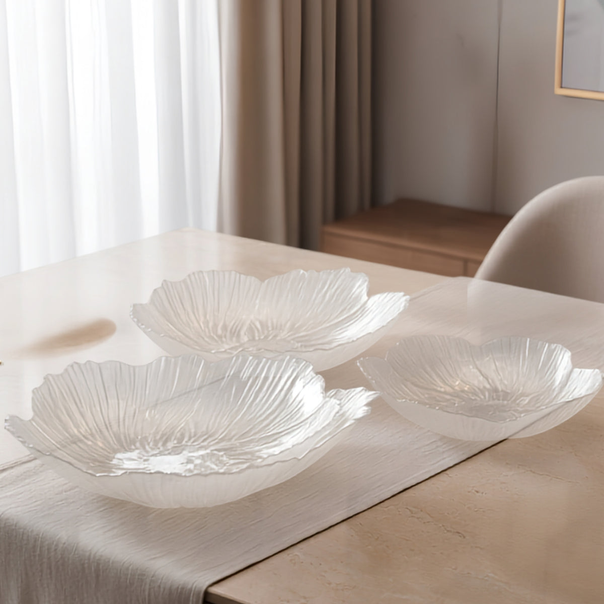 Overhead view of three translucent crystal glass fruit plates in different 