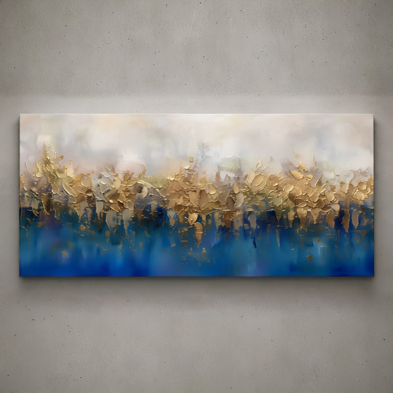 A wide rectangular abstract canvas painting mounted on a textured gray wall. The artwork features a soft cream and beige upper section blending into a deep blue lower section, with layered brushstrokes and reflective gold-like highlights across the center.