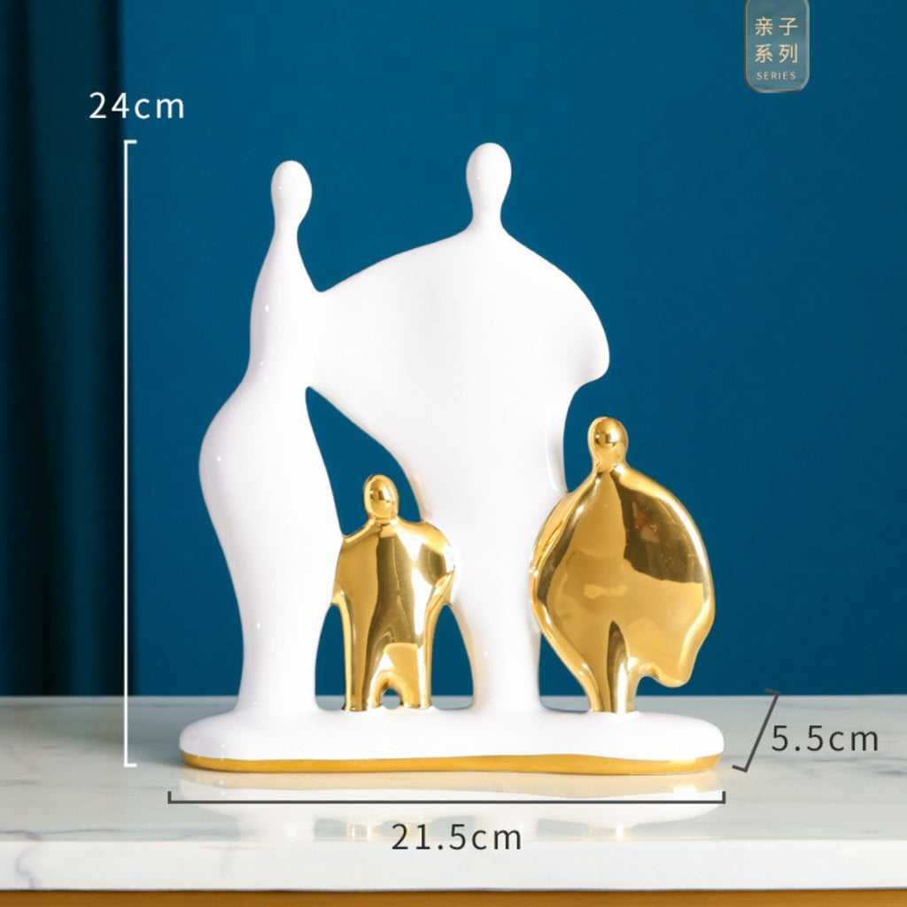 Decorative sculpture of a family with white and gold figures on a blue background