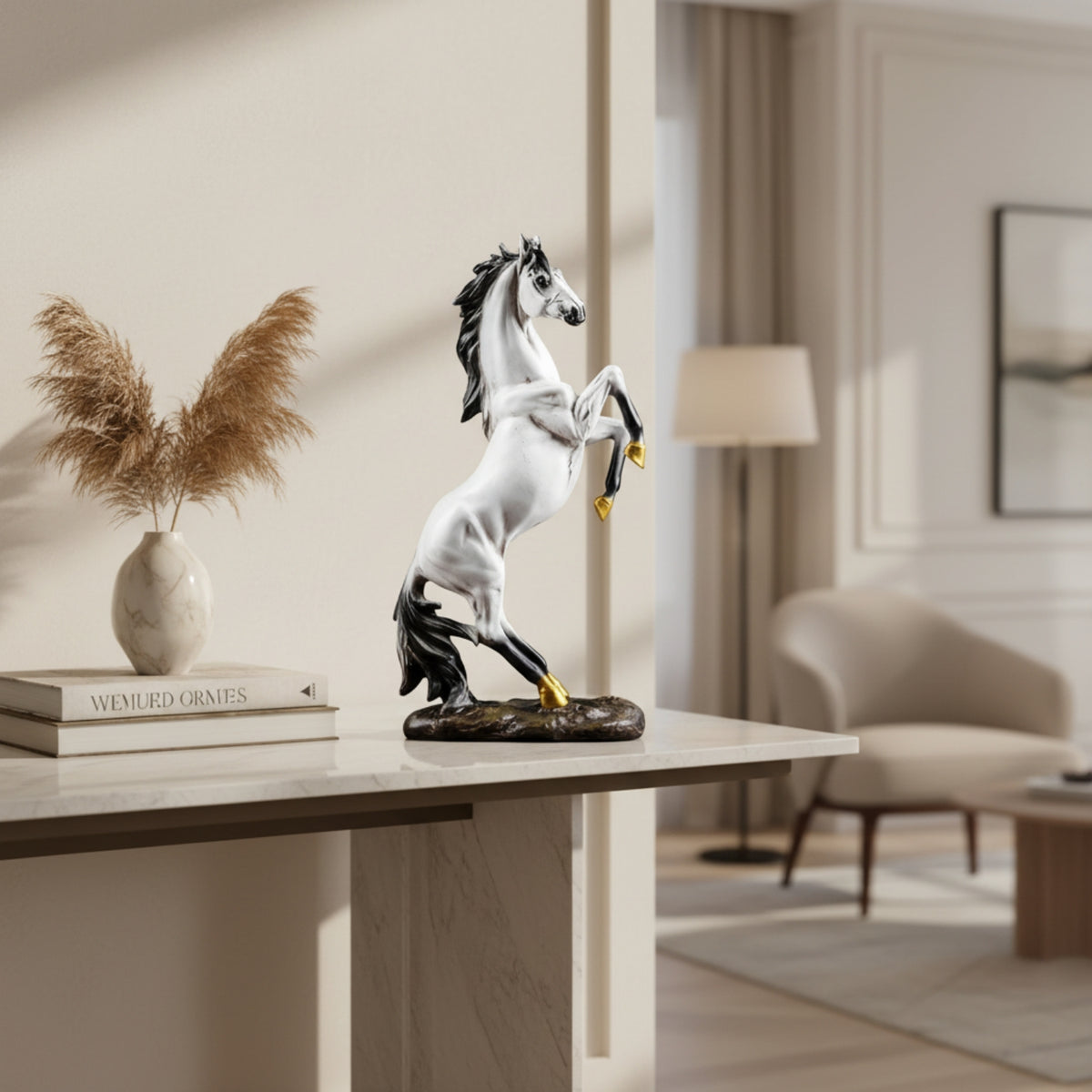 A decorative rearing horse statue in white and black with small gold accents on the hooves, displayed on a console table in a modern living room setting.