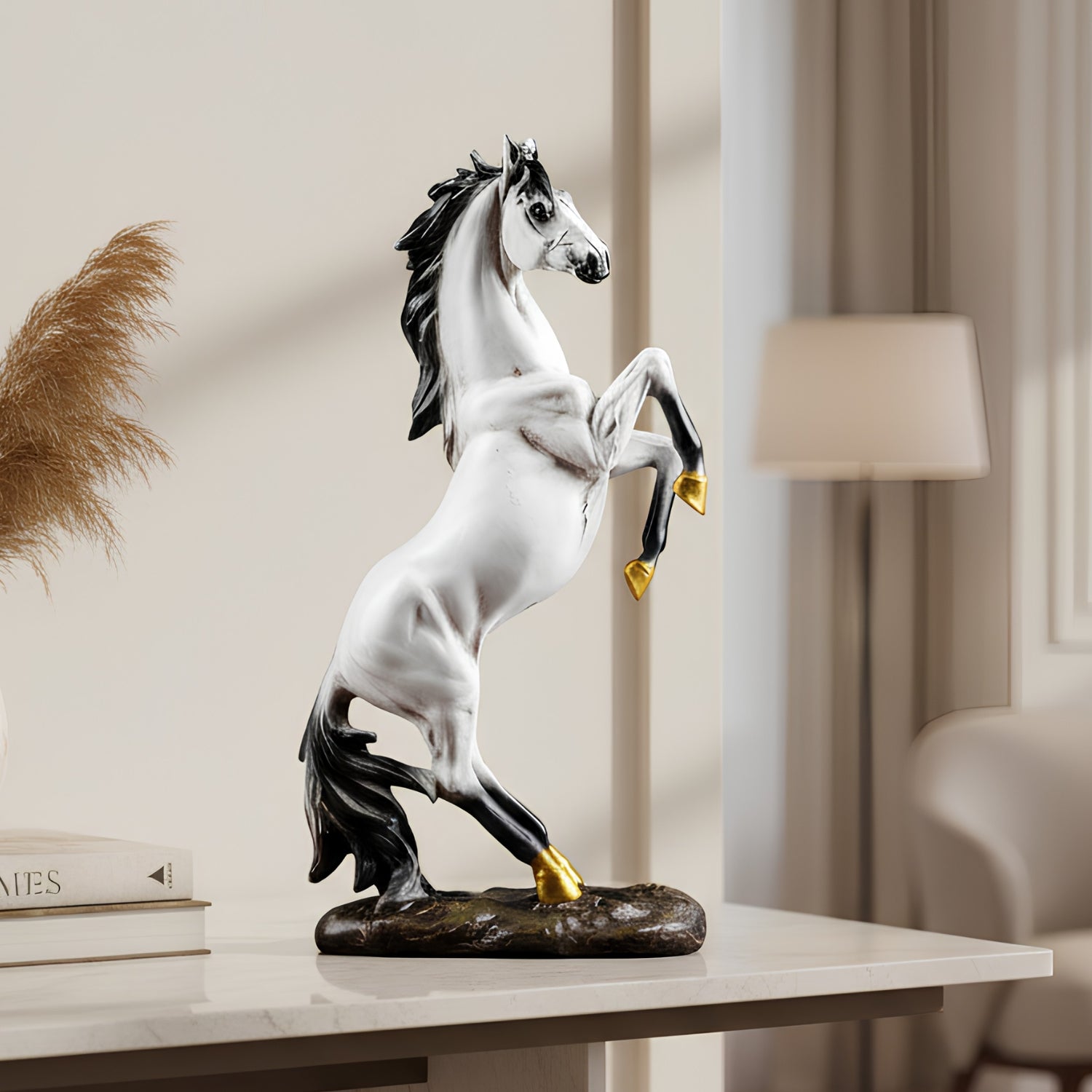 A white and black rearing horse figurine with gold-colored hooves, displayed on a white marble table in a modern, softly lit room.