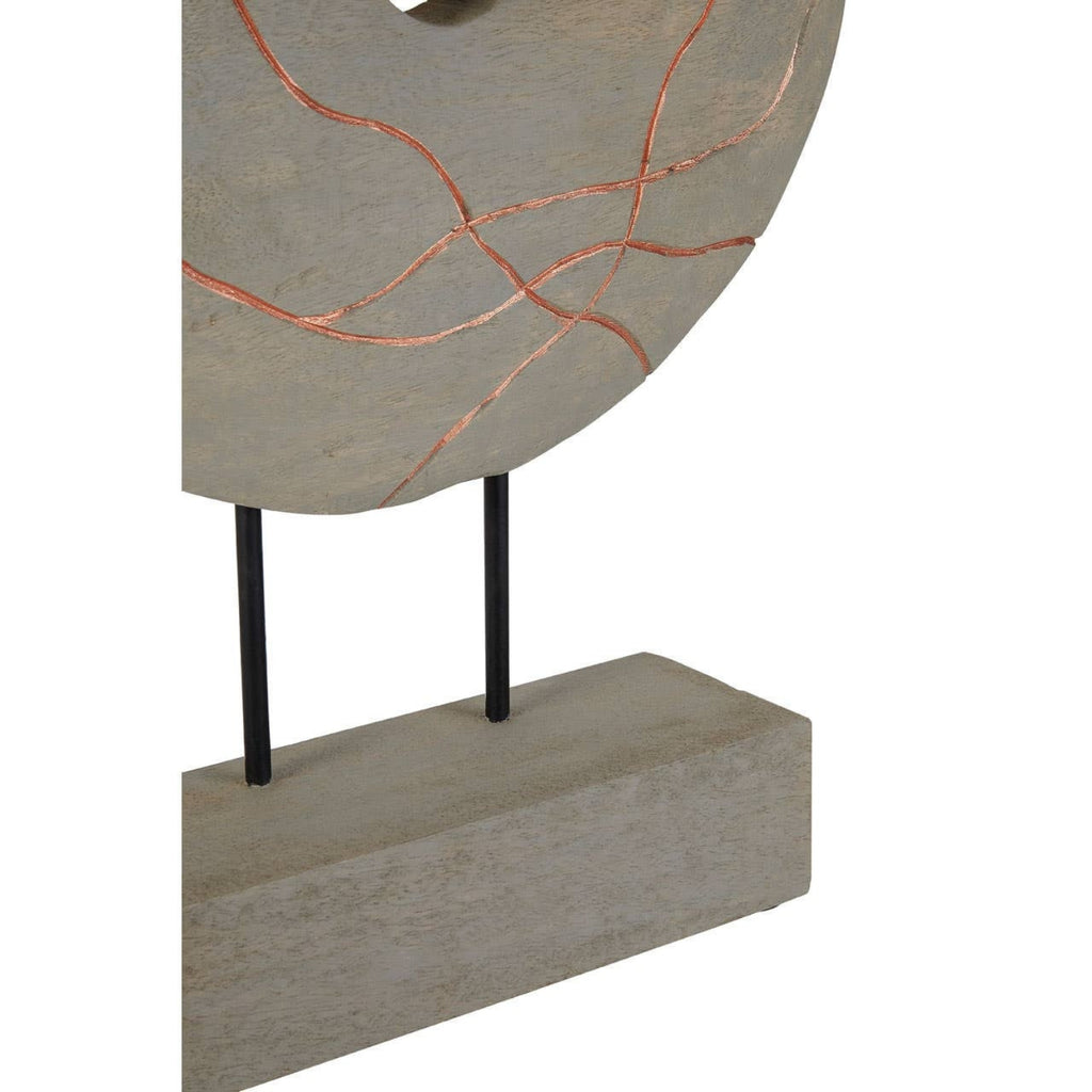 Decorative round object with a textured surface on a stand against a white background