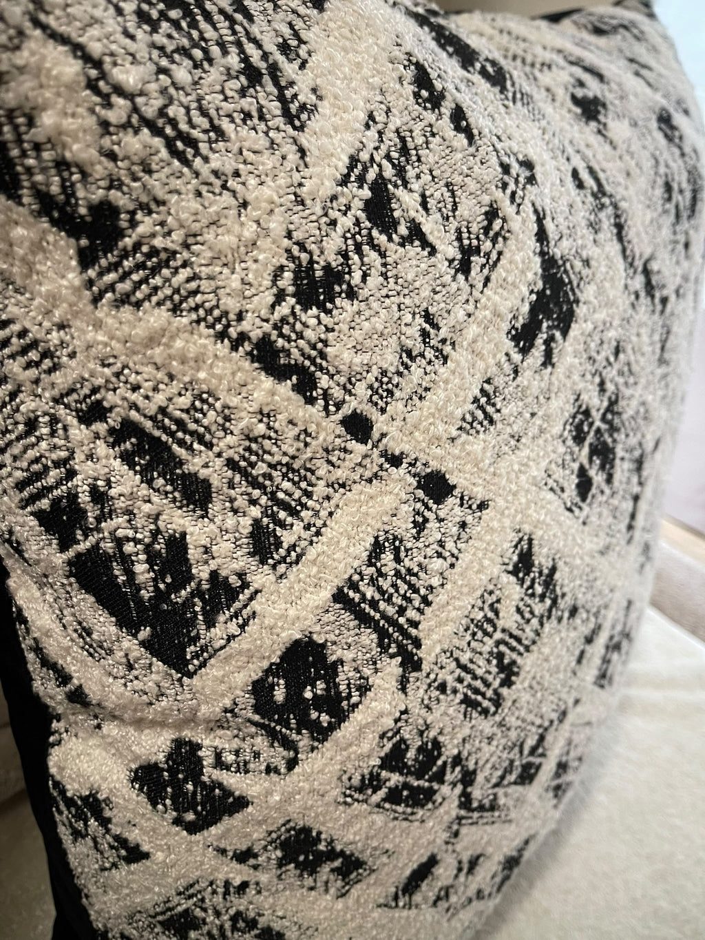 Close-up of the Galaxy cushion's textured cream and black geometric patterned front