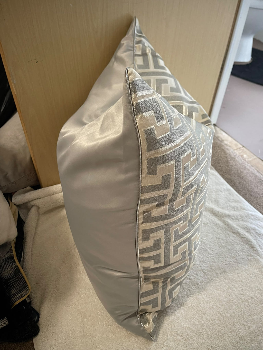 Side view of Maze grey and cream cushion showing plain reverse and piped edge