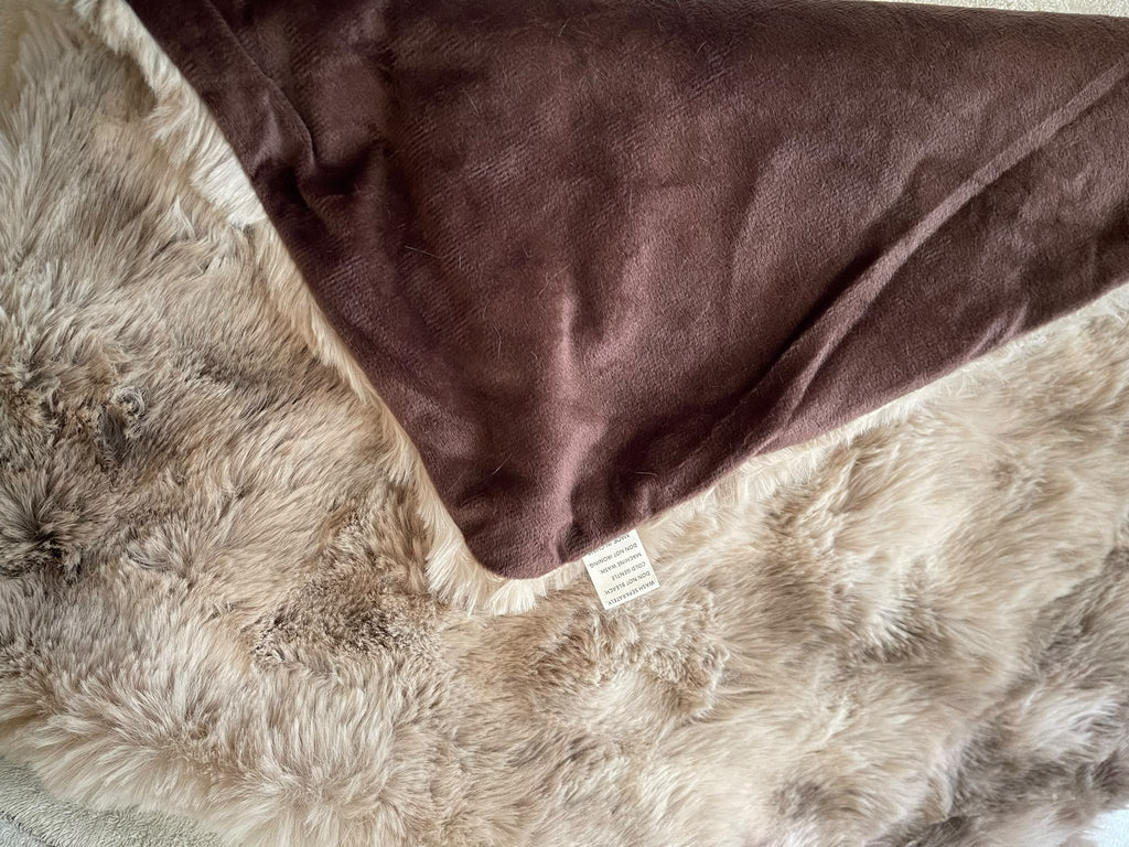 Close-up of brown and beige shaggy cushion texture and brown reverse