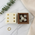 Ivory and gold dice box open on table in playroom