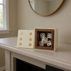 Ivory and gold dice box flat lay on marble surface