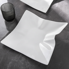 Sculptural Wave Ceramic Dinner Plate on dark slate luxury restaurant setting