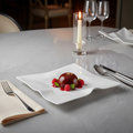 Sculptural Wave Ceramic Dinner Plate on marble dining table with candlelight