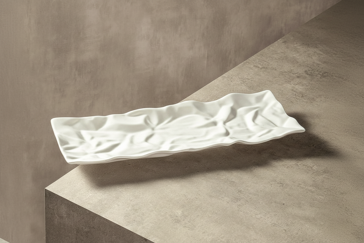 Sculptural ceramic tray empty angled view on marble surface