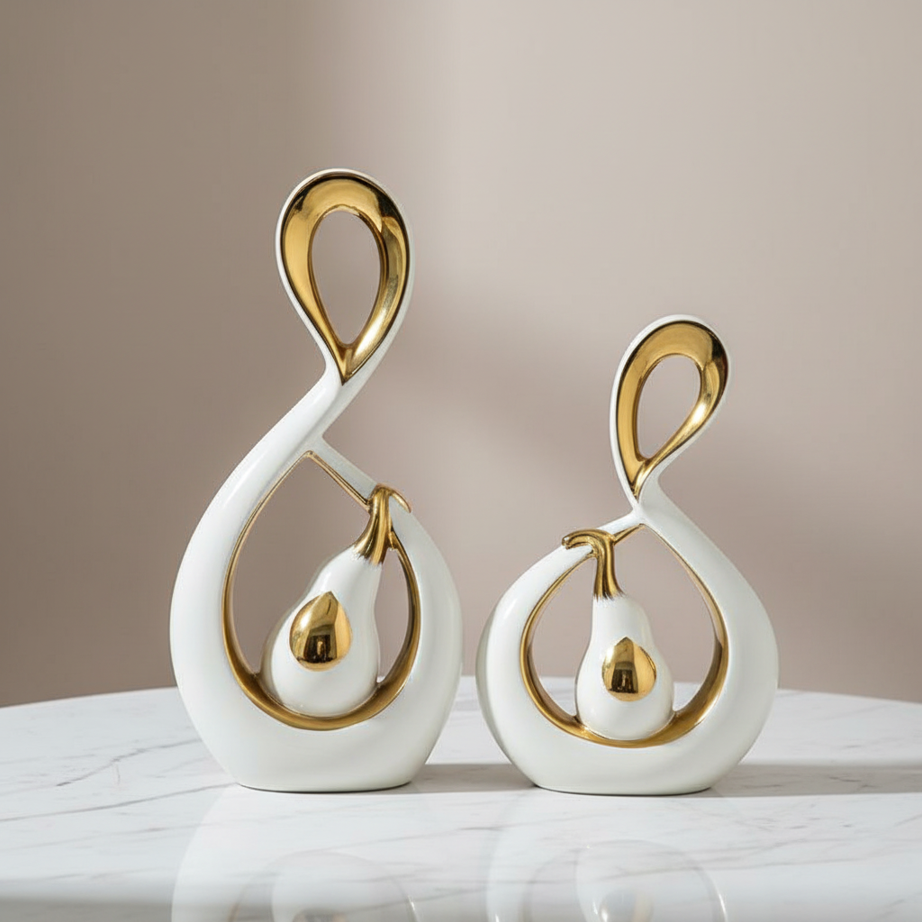 White and gold abstract ceramic sculpture set on marble surface