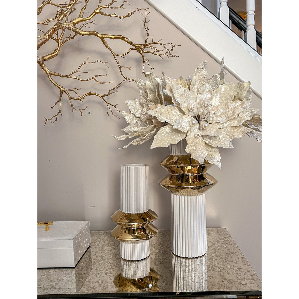 Ribbed white and gold vases styled with white florals on a console table