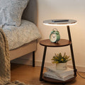 3-tier LED side table styled next to bed with alarm clock and plant