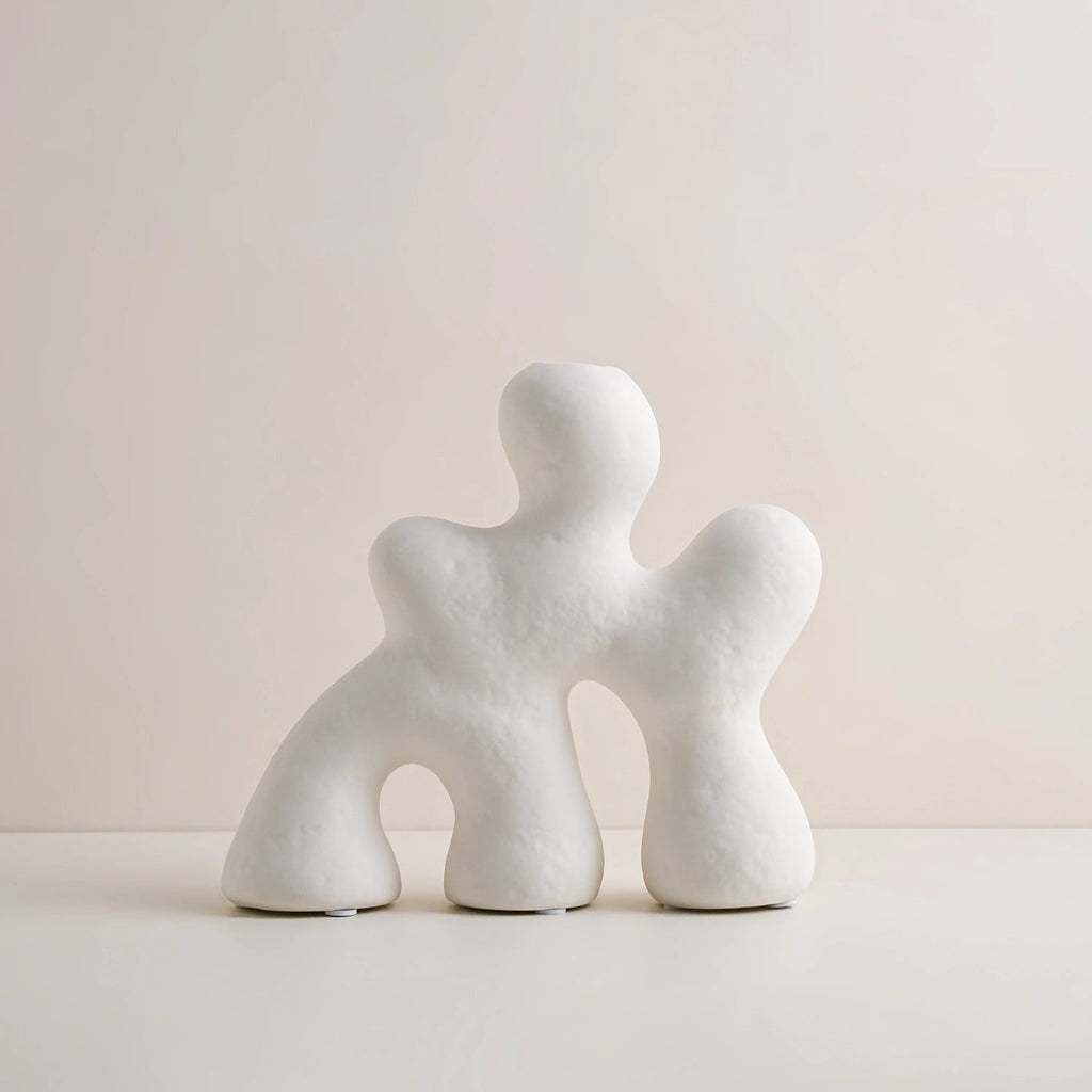 White abstract textured sculpture set of two organic human forms on cream background – product shot